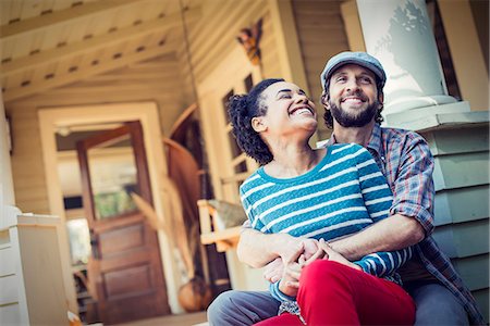 pillars for front porch - A couple, a man and woman seated on the porch steps, laughing. Stock Photo - Premium Royalty-Free, Code: 6118-08521975
