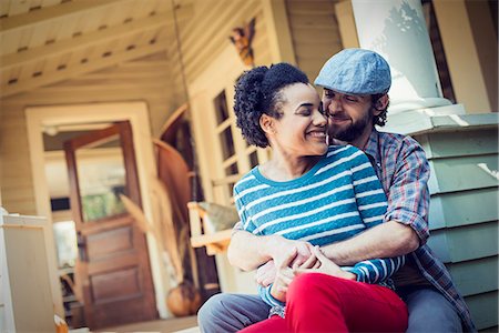 pictures people sitting front steps house - A couple, a man and woman seated on the porch steps, laughing. Stock Photo - Premium Royalty-Free, Code: 6118-08521976