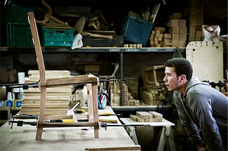 simsearch:6118-08088600,k - A man working in a furniture maker's workshop assembling a chair. Photographie de stock - Premium Libres de Droits, Code: 6118-08659747