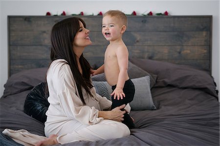 family playing bed laughing - A woman playing with her young son. Stock Photo - Premium Royalty-Free, Code: 6118-08659782