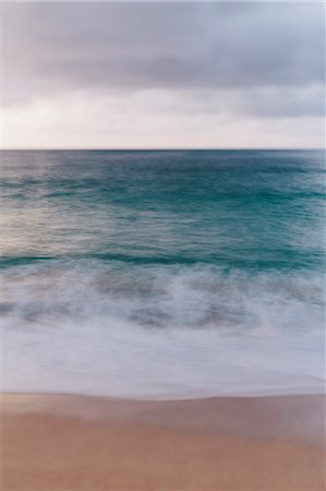 The ocean viewed from the beach, waves breaking on the beach and overcast sky. Stock Photo - Premium Royalty-Free, Code: 6118-08659869