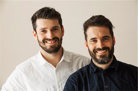 front of a bakery store - Portrait of two bearded men smiling at the camera. Stock Photo - Premium Royalty-Free, Code: 6118-08660018