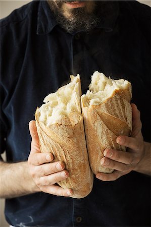 england food images - Close up of a baker holding two freshly baked loaves of bread. Stock Photo - Premium Royalty-Free, Code: 6118-08660037