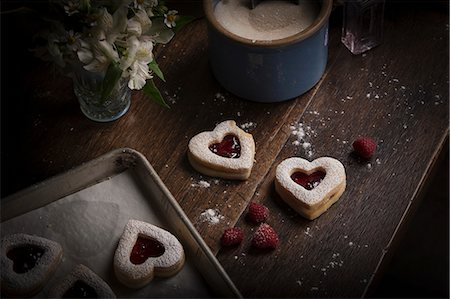 Valentine's Day baking, high angle view of a baking tray with heart shaped biscuits. Stock Photo - Premium Royalty-Free, Code: 6118-08660148