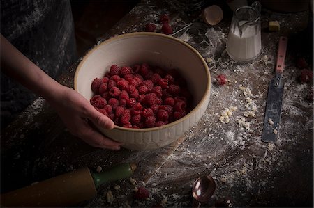 Valentine's Day baking. A bowl of fresh raspberries on a floury table. Stock Photo - Premium Royalty-Free, Code: 6118-08660189