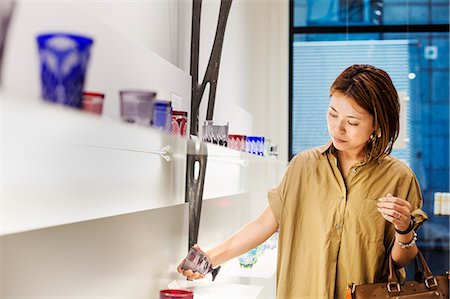 Customer in a shop selling Edo Kiriko cut glass in Tokyo, Japan. Stock Photo - Premium Royalty-Free, Code: 6118-08761992