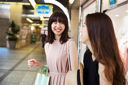 simsearch:6118-07813281,k - Two young women with long brown hair in a shopping centre. Stock Photo - Premium Royalty-Free, Code: 6118-08762074