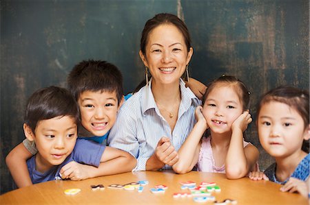 A group of children, boys and girls in a classroom with their teacher. Stock Photo - Premium Royalty-Free, Code: 6118-08762148