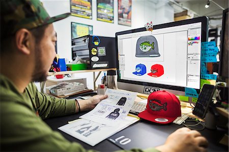 person and computer and cad - A man, a designer working on screen creating designs for baseball caps. Stock Photo - Premium Royalty-Free, Code: 6118-08762177