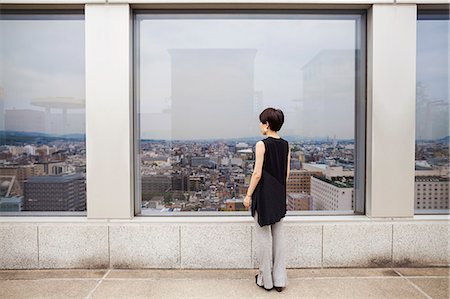 simsearch:6118-07813281,k - A woman standing looking over a city from a high viewing point. Stock Photo - Premium Royalty-Free, Code: 6118-08762186