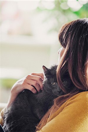 simsearch:6118-08725493,k - A woman stroking a cat. Stock Photo - Premium Royalty-Free, Code: 6118-08725441