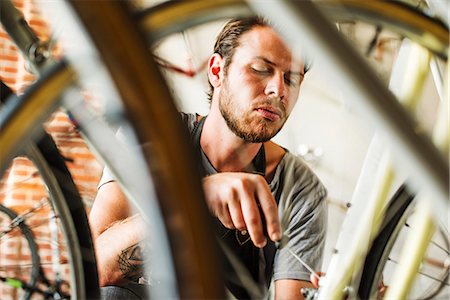 simsearch:614-08641748,k - A man working in a bicycle repair shop. Stock Photo - Premium Royalty-Free, Code: 6118-08725699