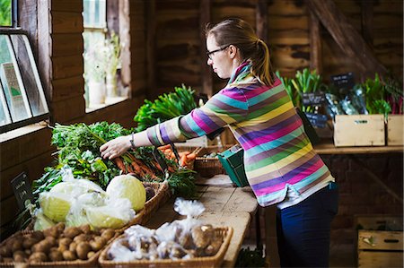 A woman handling produce in a farm shop. Photographie de stock - Premium Libres de Droits, Code: 6118-08729246