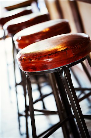 Close up of a row of bar stools in a restaurant. Stock Photo - Premium Royalty-Free, Code: 6118-08729224