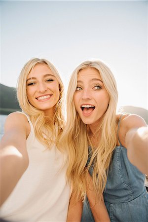 Portrait of two blond sisters on a sail boat. Stock Photo - Premium Royalty-Free, Code: 6118-08729445