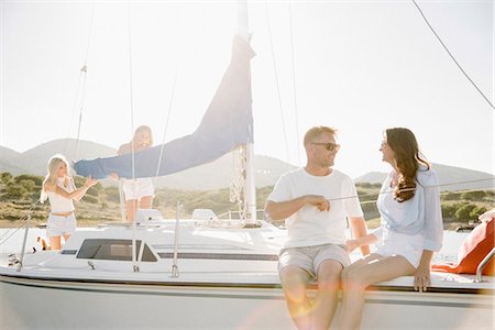 Man and woman sitting on a sail boat. Stock Photo - Premium Royalty-Free, Code: 6118-08729421