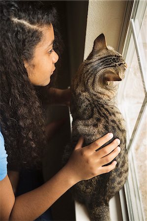 simsearch:6118-08725493,k - A young girl with a cat at a window. Stock Photo - Premium Royalty-Free, Code: 6118-08883057