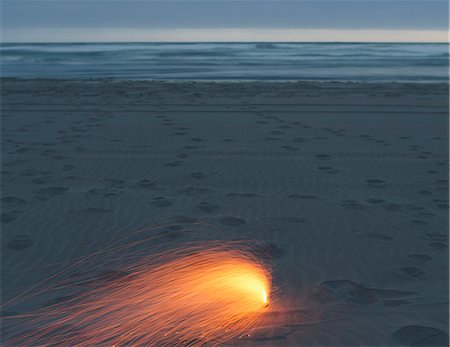 Long exposure image of firework on the sand on Long Beach Peninsula Stock Photo - Premium Royalty-Free, Code: 6118-08827555