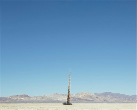 Rocket shooting into vast, desert sky, Black Rock Desert, Nevada Stock Photo - Premium Royalty-Free, Code: 6118-08827569