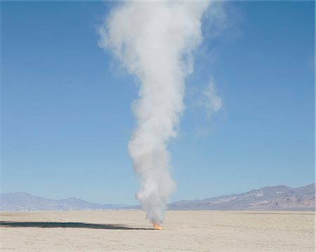 Smoke and flames from destroyed rocket, Black Rock Desert, Nevada Stock Photo - Premium Royalty-Free, Code: 6118-08827570