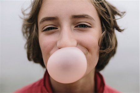 Eleven year old girl blowing bubble gum bubble Stock Photo - Premium Royalty-Free, Code: 6118-08827616