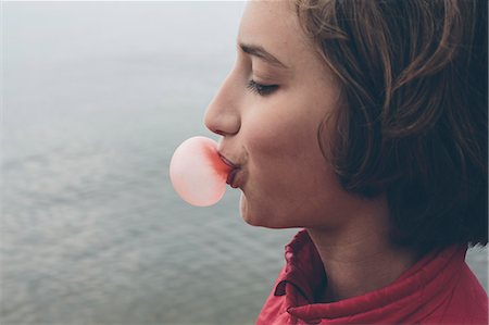 Eleven year old girl blowing bubble gum bubble Stock Photo - Premium Royalty-Free, Code: 6118-08827620