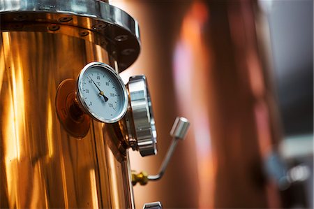 Close up of a gauge on a copper brew kettle or fermentation chamber. Stock Photo - Premium Royalty-Free, Code: 6118-08947482