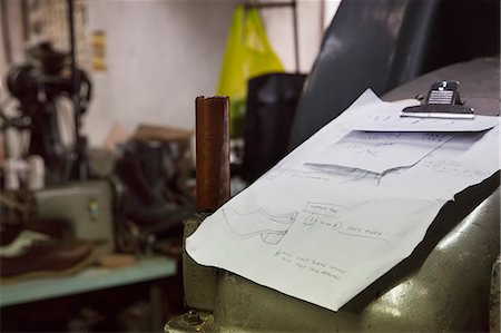 simsearch:6118-08947769,k - Close up of handwritten notes and drawings on a clipboard in a shoemaker's workshop. Stock Photo - Premium Royalty-Free, Code: 6118-08947656