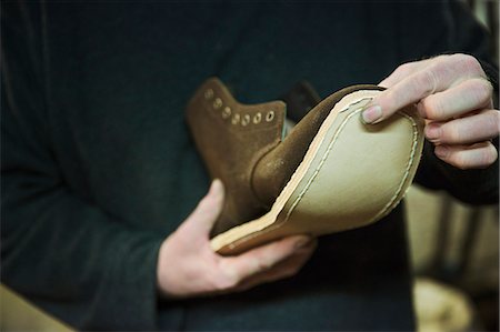 simsearch:693-03316521,k - Close up of worker in a shoemaker's workshop, attaching a sole to a leather boot. Foto de stock - Sin royalties Premium, Código: 6118-08947676