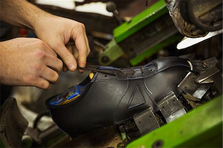 simsearch:6118-08947633,k - Close up of man standing in a shoemaker's workshop, tying the laces of a leather cycling shoe. Photographie de stock - Premium Libres de Droits, Code: 6118-08947628
