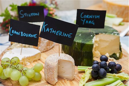 red grape - Close up of cheese board with a selection of English cheeses. Stock Photo - Premium Royalty-Free, Code: 6118-08947769