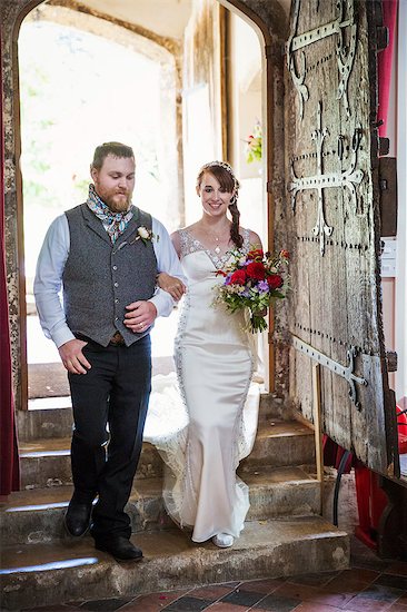 Smiling bride and groom entering church. Stock Photo - Premium Royalty-Free, Image code: 6118-08947776