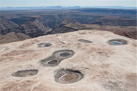 simsearch:841-08421468,k - Water pools and rock formations on rocks overlookng the San Juan Canyon from Muley Point, Bears Ears National Monument, Utah Stock Photo - Premium Royalty-Free, Code: 6118-08947878