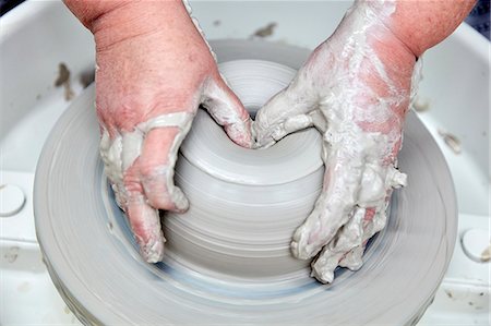 simsearch:6118-08660001,k - A person using a potter's wheel, throwing a clay pot and using thumbs to shape the wet clay. Seen from above. Stock Photo - Premium Royalty-Free, Code: 6118-08947824