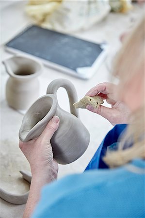 simsearch:6118-08660001,k - A woman using her hands to shape and smooth a wet clay jug to match another, making a pair. Stock Photo - Premium Royalty-Free, Code: 6118-08947838