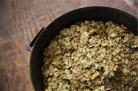 Close up high angle view of some dried hops in a container in a brewery. Stock Photo - Premium Royalty-Free, Code: 6118-08971335