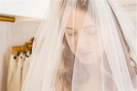 simsearch:6118-08971470,k - Head and shoulders of a woman trying on a net bridal veil in a specialist wedding dress shop. Photographie de stock - Premium Libres de Droits, Code: 6118-08971460