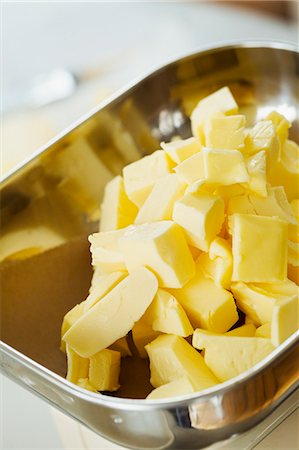 simsearch:6118-08971487,k - Close up high angle view of pieces of butter in a metal dish. Stockbilder - Premium RF Lizenzfrei, Bildnummer: 6118-08971483