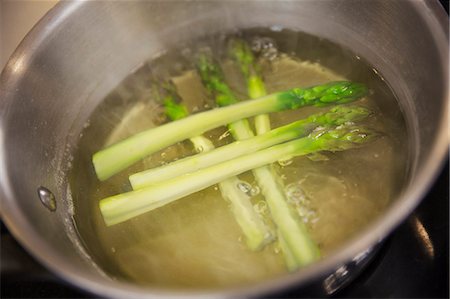 simsearch:6118-08947538,k - Close up high angle view of green asparagus spears in a pot of water. Stock Photo - Premium Royalty-Free, Code: 6118-08971606