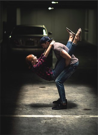 simsearch:693-03474515,k - A couple dancing in an underground parking lot. Stock Photo - Premium Royalty-Free, Code: 6118-08991382