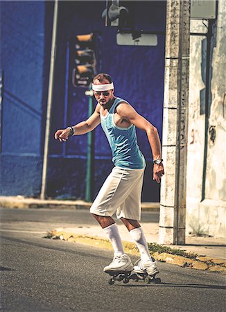 sweaty man - A man roller-skating in a street. Foto de stock - Sin royalties Premium, Código: 6118-08991541