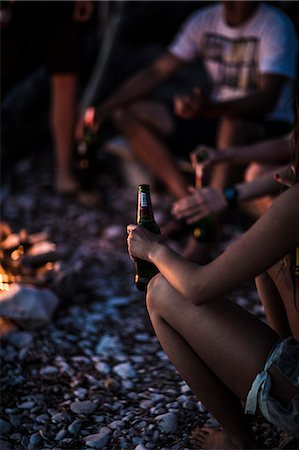 simsearch:6118-09027946,k - A group of young people gathered on a beach around a campfire. Stock Photo - Premium Royalty-Free, Code: 6118-08991643