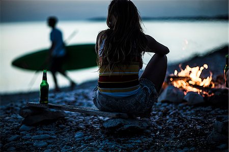 simsearch:6118-08991633,k - A group of young people gathered on a beach around a campfire. Stock Photo - Premium Royalty-Free, Code: 6118-08991645