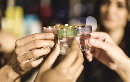 simsearch:6118-08991602,k - A group at a party holding shot glasses and celebrating. Stock Photo - Premium Royalty-Free, Code: 6118-08991600