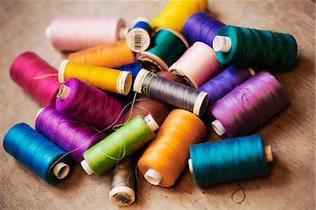 pink cloth - Bobbins of wound thread, silks and cottons in bright colours. Stock Photo - Premium Royalty-Free, Code: 6118-08910345