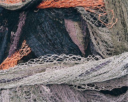 Close up of a pile of tangled up commercial fishing nets. Stock Photo - Premium Royalty-Free, Code: 6118-08910519