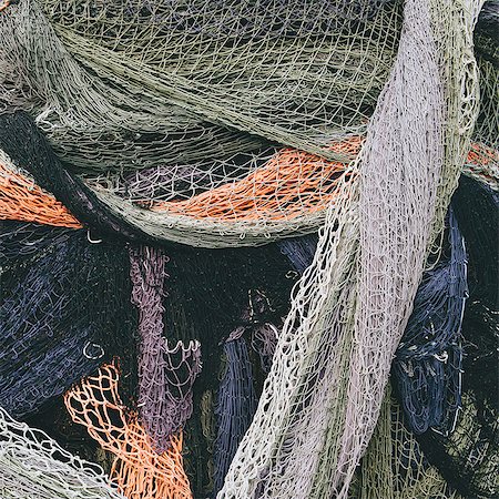 simsearch:6118-07352688,k - Close up of a pile of tangled up commercial fishing nets. Stock Photo - Premium Royalty-Free, Code: 6118-08910521