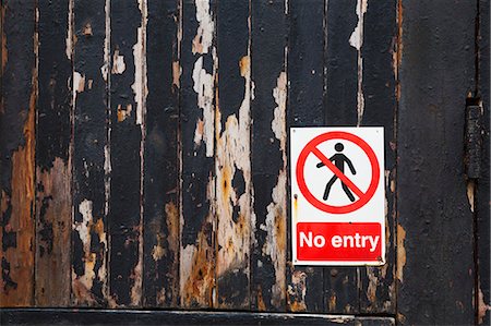 Close up of a 'No Entry' sign on a weathered wooden wall. Stock Photo - Premium Royalty-Free, Code: 6118-08928140