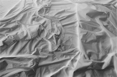 Black and white close up of wrinkled cotton sheets on bed. Stock Photo - Premium Royalty-Free, Code: 6118-09059460