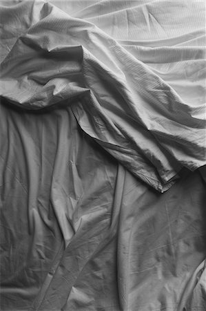 Black and white close up of wrinkled cotton sheets on bed. Stock Photo - Premium Royalty-Free, Code: 6118-09059462